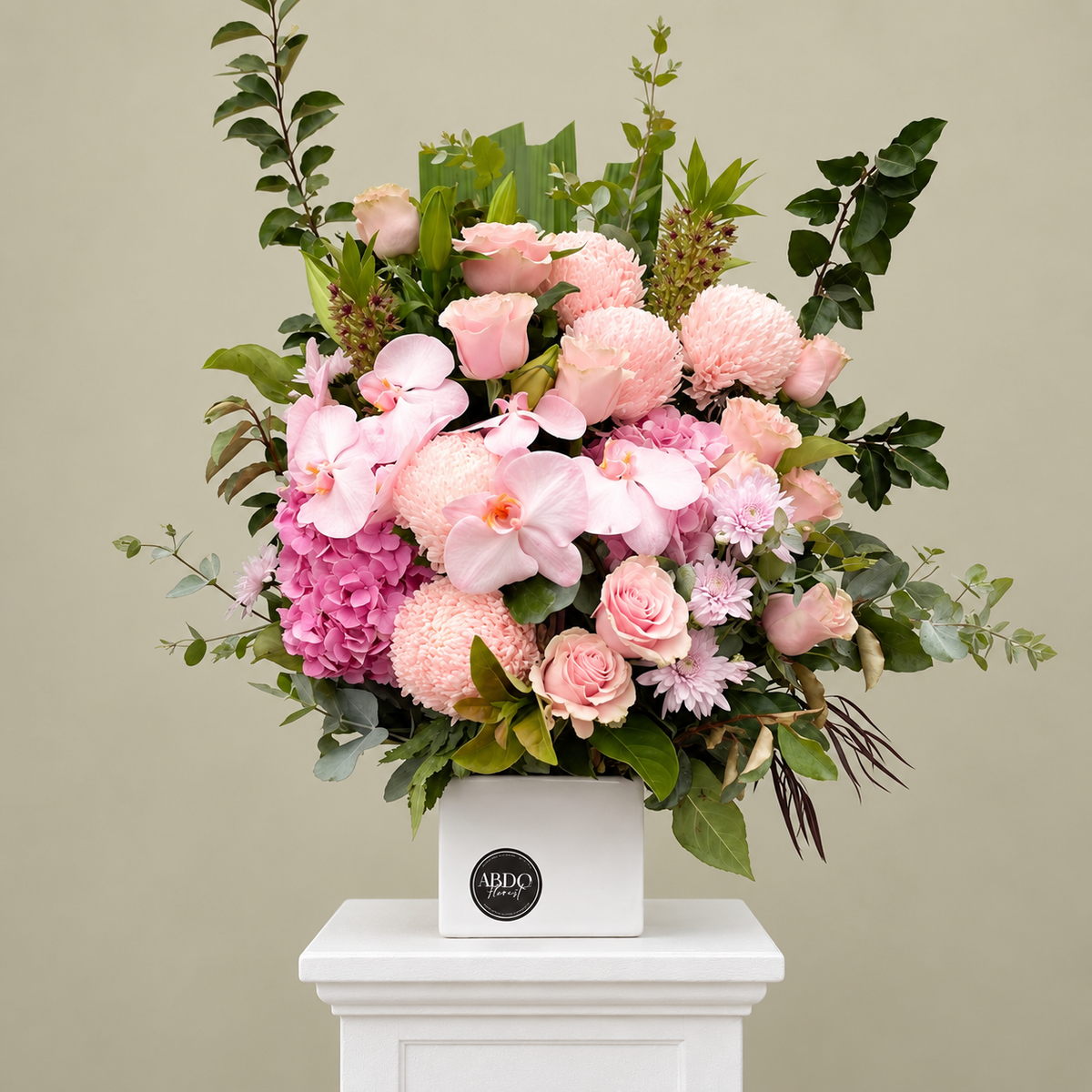 Soft pink arrangement with an orchid stem in a ceramic vase, by Abdo Florist Sydney