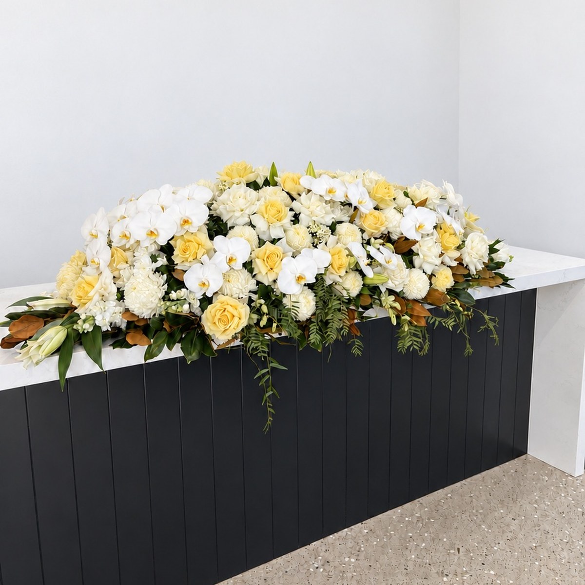 Soft Yellow and White Orchid Casket Flowers – funeral casket spray by Abdo Florist Sydney