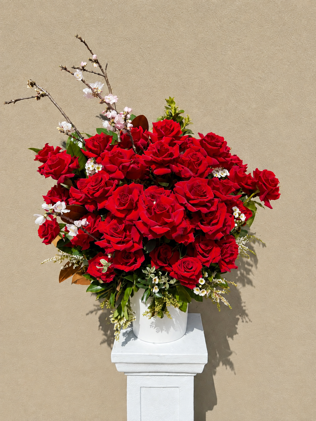 Statement red rose arrangement with flowering branches, by Abdo Florist Sydney