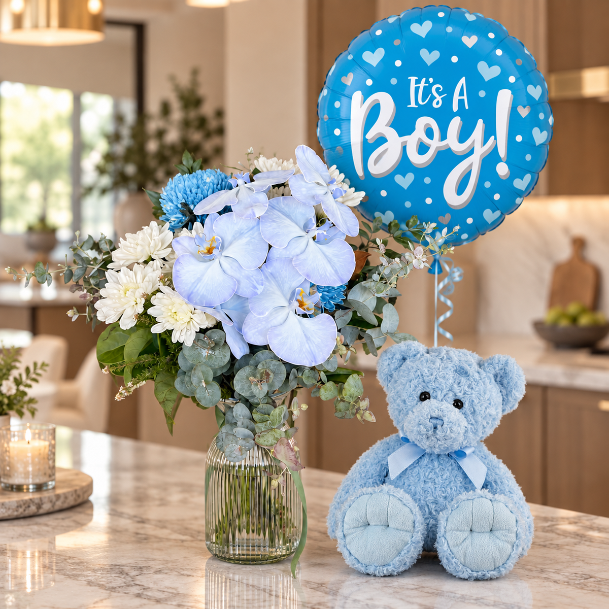 Blue and white new baby boy arrangement with plush teddy and It's a Boy balloon