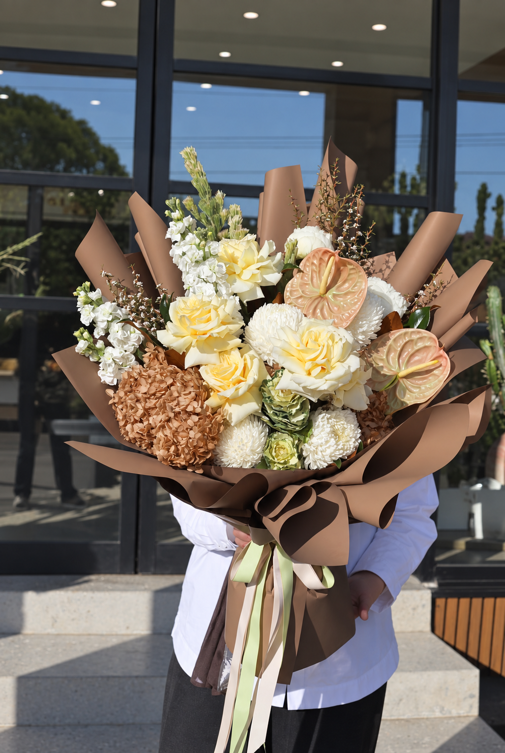 Creamy roses and anthuriums in chocolate-brown wrap, by Abdo Florist Sydney