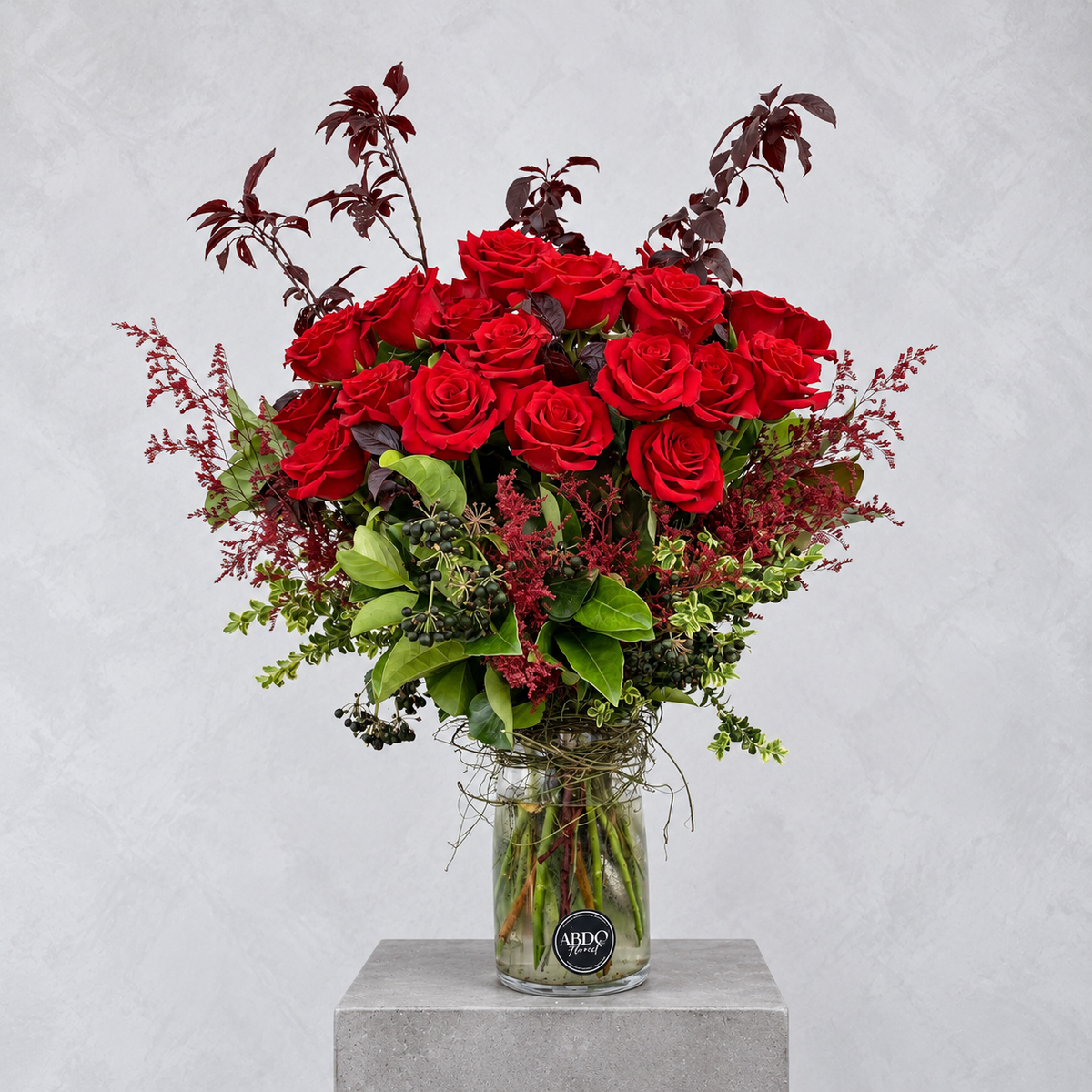 Red roses arranged in a clear glass vase, by Abdo Florist Sydney