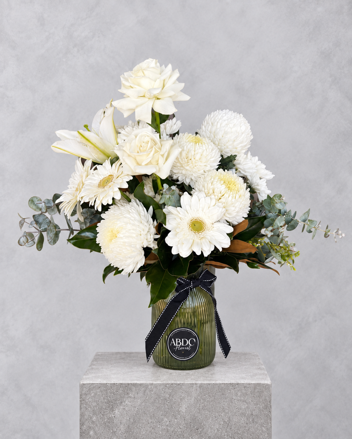 All-white arrangement with roses, lilies and gerberas in a glass vase, by Abdo Florist Sydney