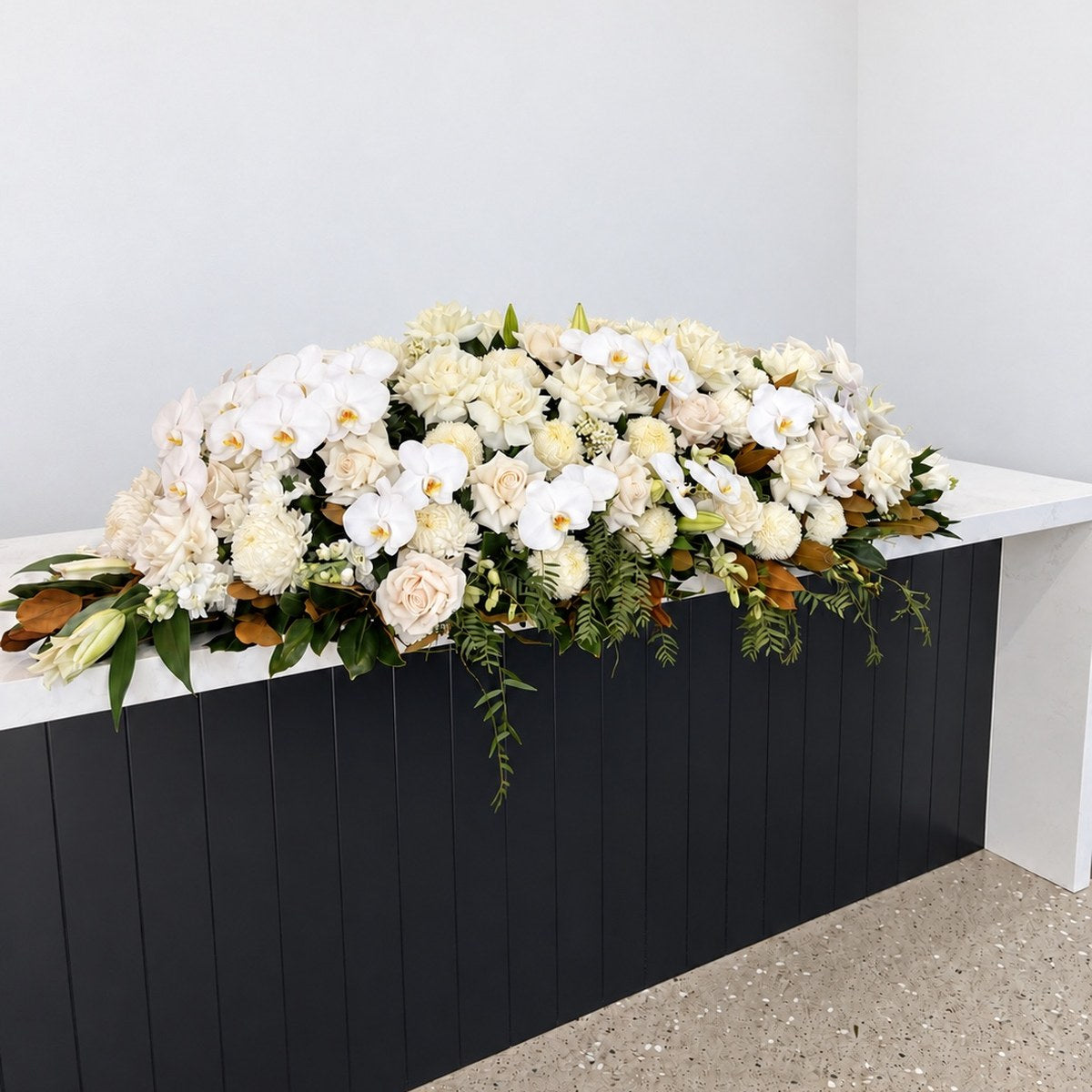 Ivory and White Orchid Casket Flowers – funeral casket spray by Abdo Florist Sydney